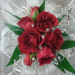 Small bouquet of red roses with silver ribbon and bead accents