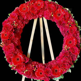 Red floral wreath on a wooden easel