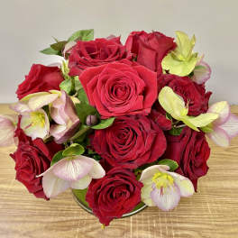 Bouquet of red roses with pale pink and green hellebore blooms