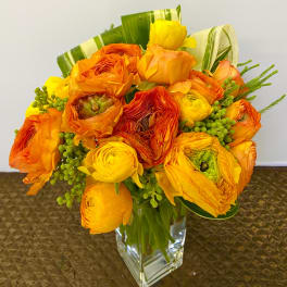 Orange and yellow bouquet in a clear glass vase