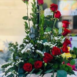 Tall arrangement of red roses with white accent flowers in a white wooden box