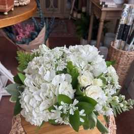 White hydrangea and rose bouquet with green foliage