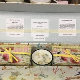 Gift box with floral soap bars and a candle