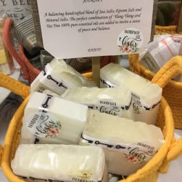 Basket of wrapped bath salt bars with a sign reading Balanced Journey