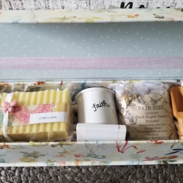 Gift box with soap, a mug, bath soak, and a wooden scoop