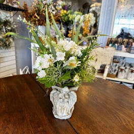 White floral arrangement in an ornate ceramic vase