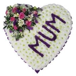 Heart-shaped floral tribute with purple lettering and pink flowers