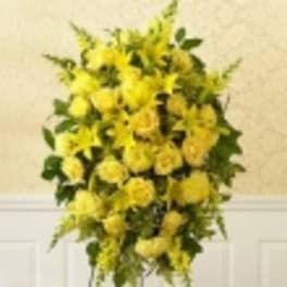 Tall arrangement of yellow flowers with green foliage