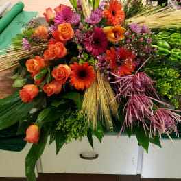 Mixed bouquet with orange roses, gerbera daisies, and purple blooms