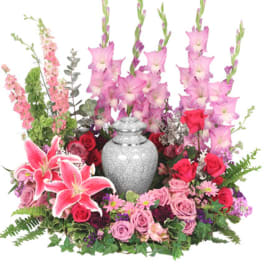Pink and red floral arrangement with a silver urn centerpiece