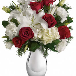 Red roses and white lilies in a clear glass vase