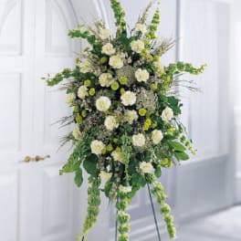Tall white and green floral standing spray on an easel
