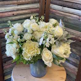 White rose and hydrangea arrangement in a glass vase