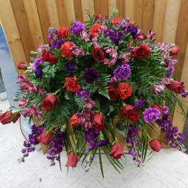 Large standing floral spray with red roses and purple flowers