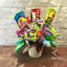 Candy bouquet in a white ribbed container with colorful ribbons