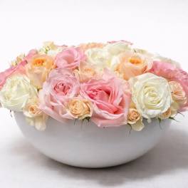 Low bowl of pink, peach, and white roses