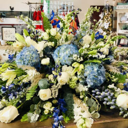 Large blue and white floral arrangement on a table