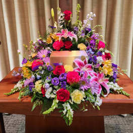 Large casket spray with pink lilies, red roses, and mixed blooms
