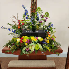 Large floral arrangement around a church crucifix