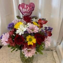 Mixed bouquet in a glass vase with a heart-shaped "I Love You" balloon