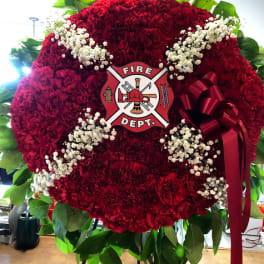 Red floral fire department wreath with white baby's breath and a ribbon