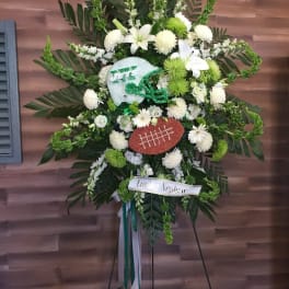 Football-themed standing floral spray with white and green flowers