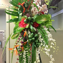 Tall tropical floral standing arrangement with orchids and bird-of-paradise