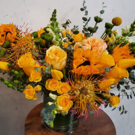 Yellow and orange mixed bouquet in a glass vase