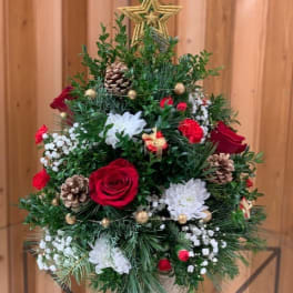 Christmas tree-shaped floral arrangement with red and white flowers