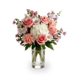 Pink roses and white flowers arranged in a clear glass vase