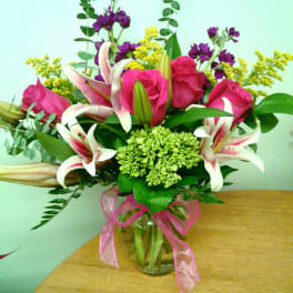 Bouquet of pink roses and white lilies in a glass vase
