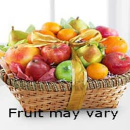 Basket of assorted fruit tied with a gold ribbon