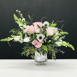 Pink roses and white anemones in a glass vase