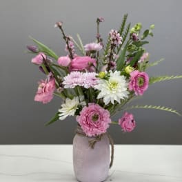 Pink and white mixed bouquet in a lavender vase