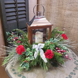 Christmas lantern centerpiece with red carnations and evergreen accents