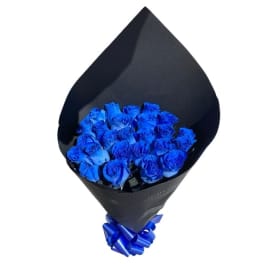 Bouquet of vivid blue roses wrapped in black paper with a matching blue ribbon