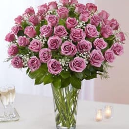 Pink roses arranged in a clear glass vase