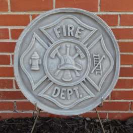 Fire department emblem plaque mounted on a brick wall