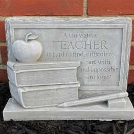 Teacher memorial plaque with books, apple, and pencil