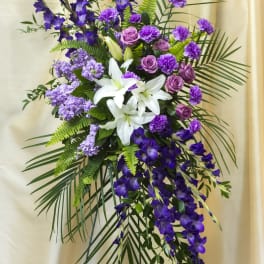 Purple and white floral standing spray with lilies and roses