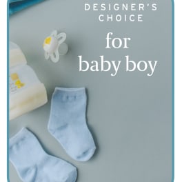 Baby socks, pacifier, and bottle on a blue card reading "designer's choice for baby boy"