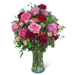 Pink and magenta rose bouquet in a clear glass vase