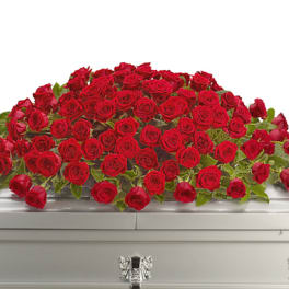 Large spray of red roses on a casket