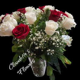 Bouquet of red and white roses in a clear glass vase