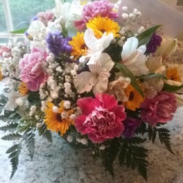 Mixed bouquet of carnations, daisies, and alstroemeria in a vase