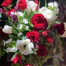 Bouquet of red and white roses with small white filler flowers