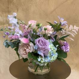 Pastel mixed flower arrangement in a clear glass vase