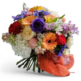 Colorful mixed bouquet with gerbera daisies, roses, and orchids