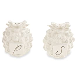 Two small white ceramic owl figurines with letter tiles on the front