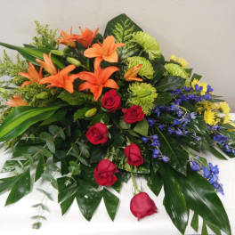 Mixed bouquet with orange lilies, red roses, and blue flowers